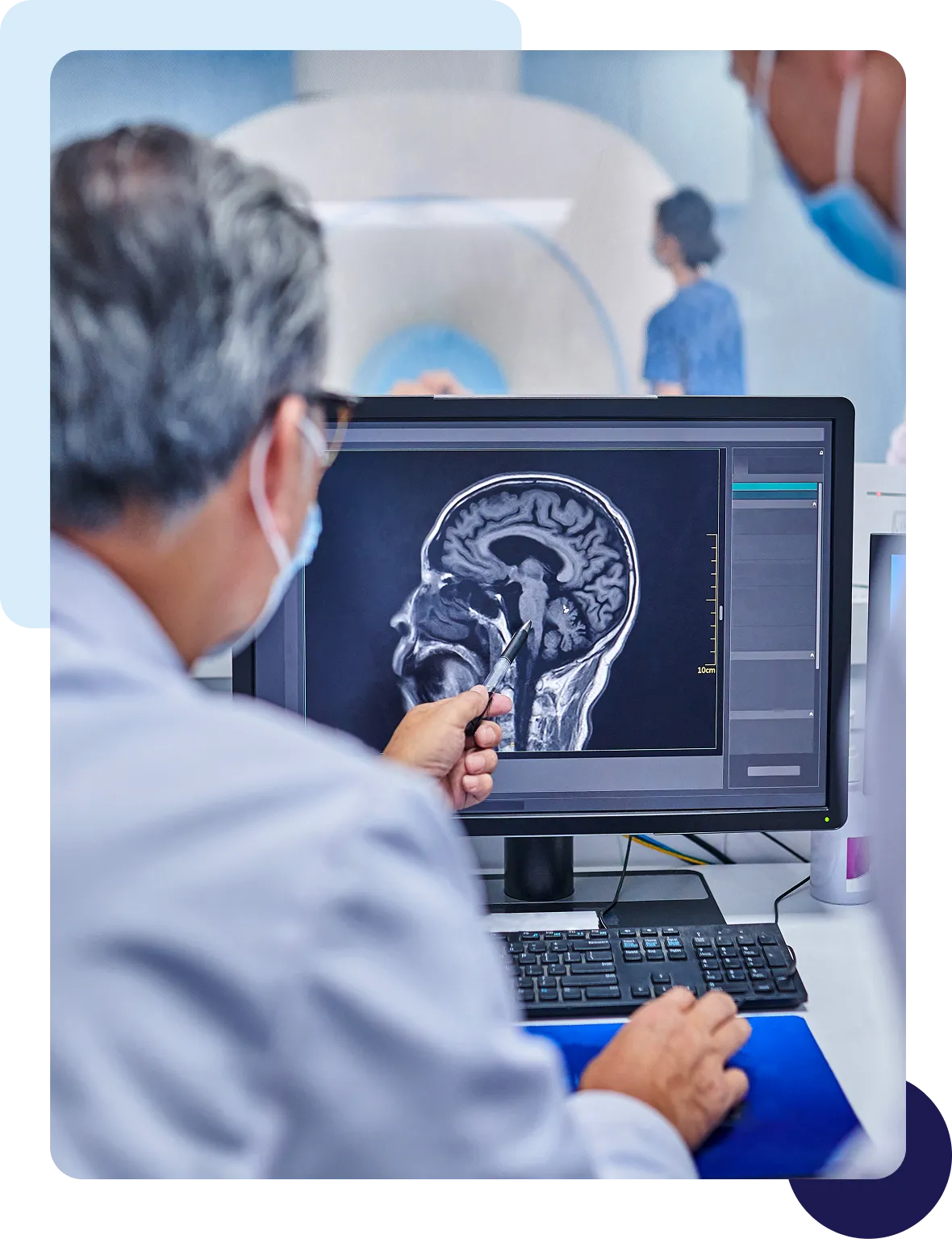 Doctor analyzing brain scan on computer screen.