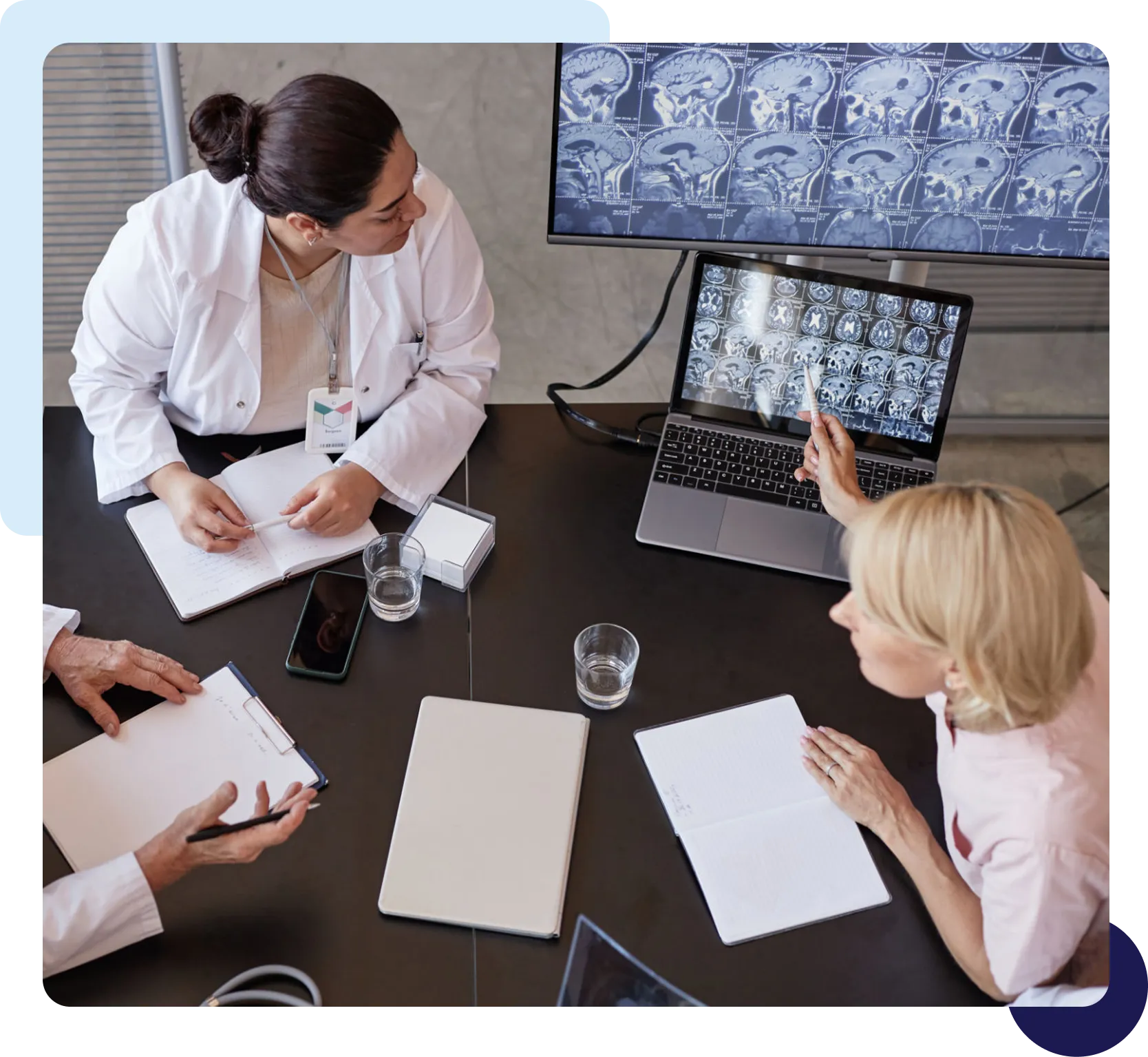 Team analyzing brain imaging on laptop